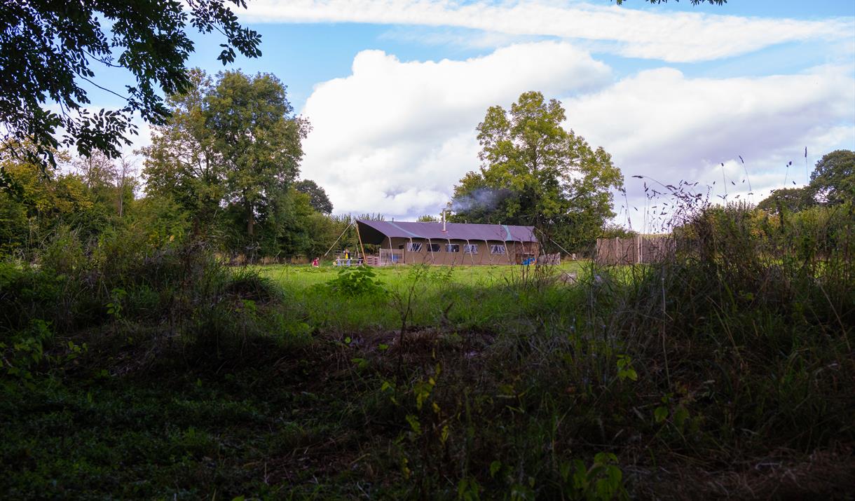 A glamping tent in a field